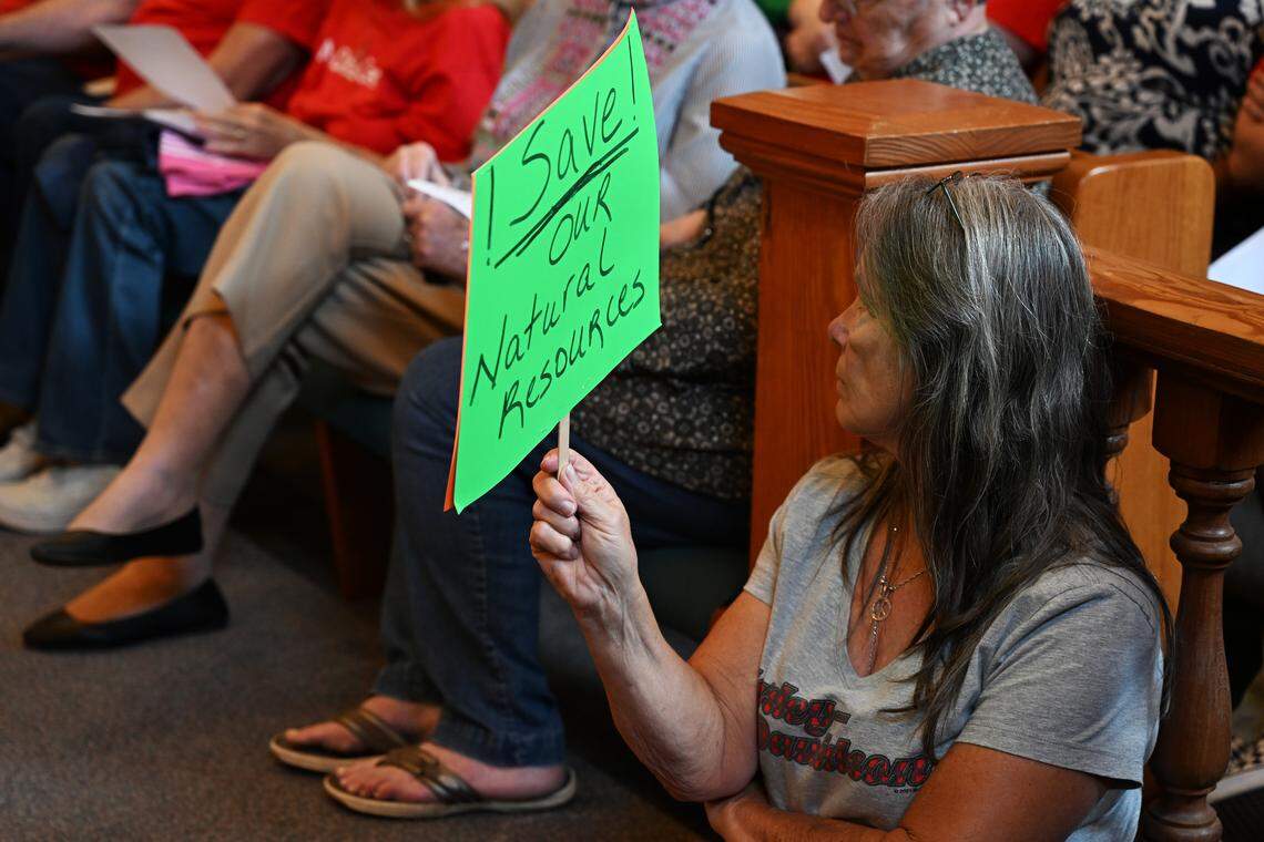 A meeting attendee holds up a “Save our Natural Resources” sign on Sept. 18 at the Twiggs County Courthouse in Jeffersonville, Georgia. The Twiggs County Board of Commissioners voted unanimously to approve the rezoning of agricultural land into land for a proposed data center with some conditions. 