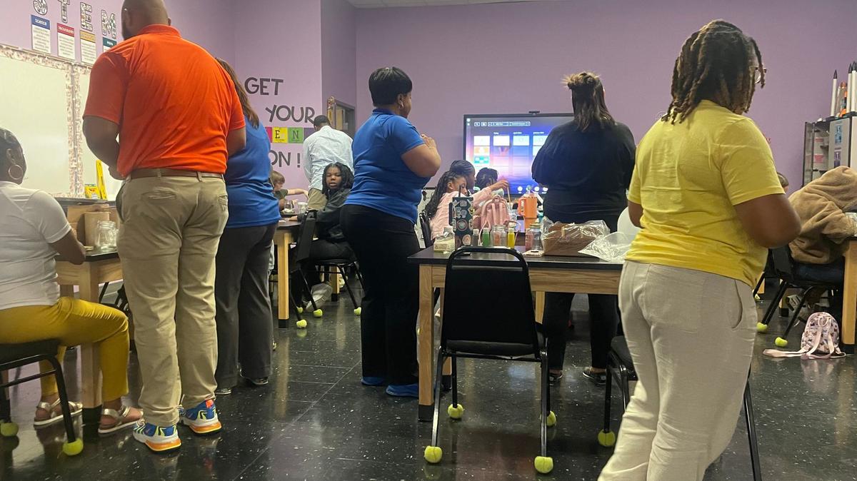 Elevent instructors circulate the classroom as students prepare their Galaxy jars.