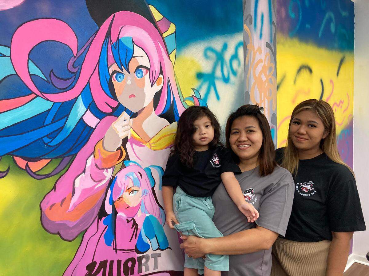 Saruedolkorn “Spicy” Pathomkrut, center, with her granddaughter, Elena, and daughter, Siri Kaewma, right, inside Pathomkrut’s new restaurant, Elena’s Noodle Bar, in Warner Robins.