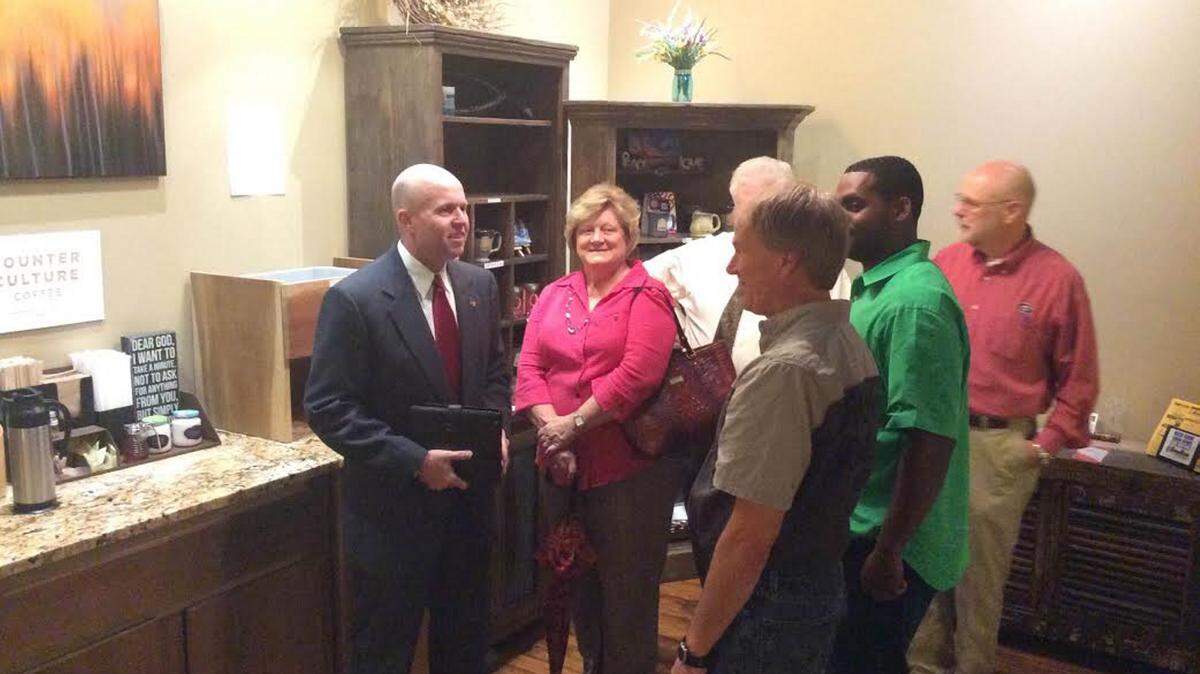 Interim Bibb County Tax Commissioner Wade McCord, far left, speaks with supporters prior to announcing his intention to seek a full term in office.