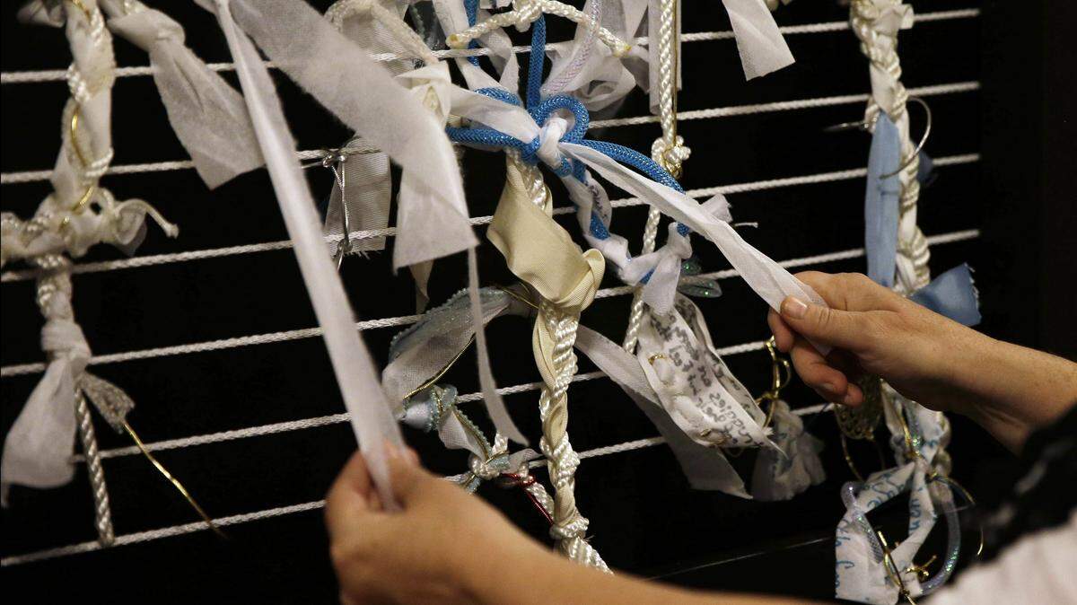 Artist Meg Saligman shows knots tied to a mock-up of an art exhibit at her studio in Philadelphia. The actual exhibit will greet Pope Francis and millions of others next month when they travel to the city. Visitors will be invited to leave their own problems behind in the form of knots affixed to its walls, or help others by loosening and removing a knot already in place.