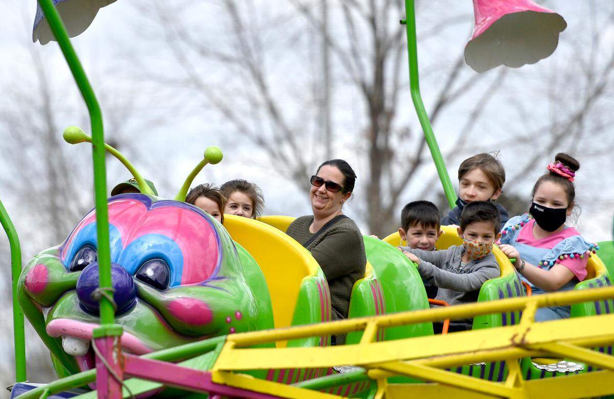 Visitors ride a caterpillar roller coaster Friday at Carolyn Crayton Park during the Cherry Blossom Festival.