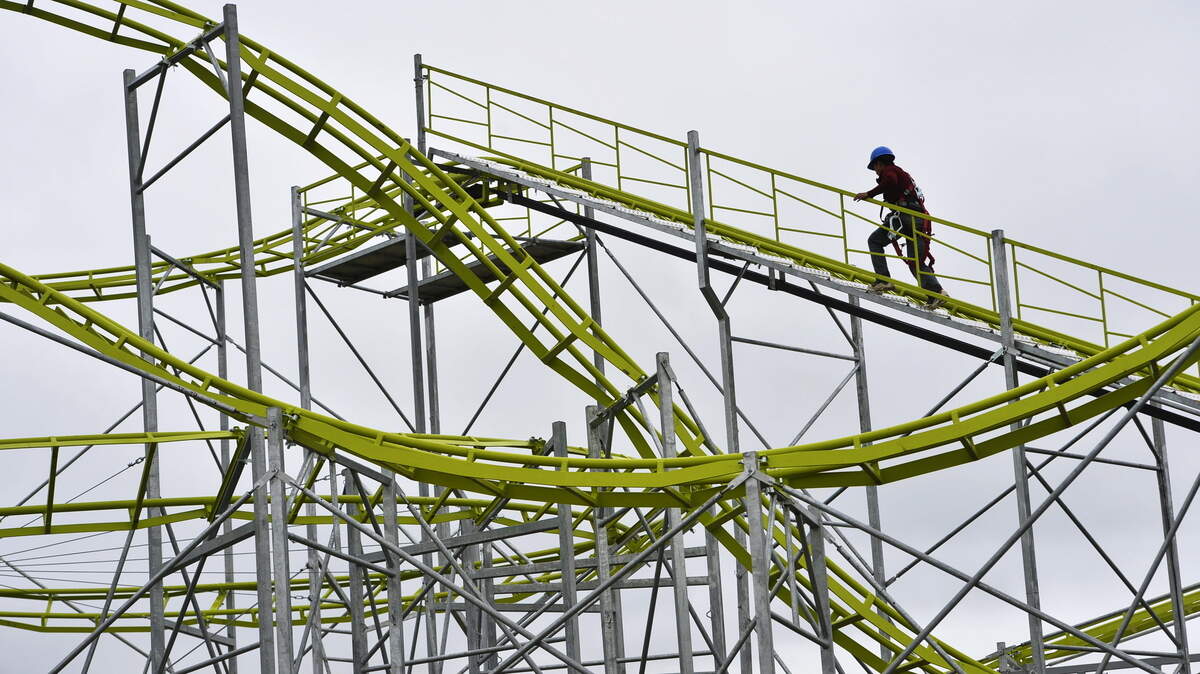 Antonio Cardeno torques down bolts that hold the brand new Galaxy roller coaster together as he and others prepared for the opening of the 2015 Georgia National Fair.