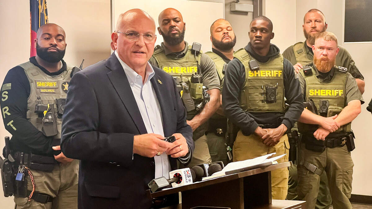 Bibb County Sheriff David Davis, surrounded by investigators, talks to the media about the capture of four escaped Macon jail inmates. One of the inmates, Johnifer Barnwell, is expected to plead guilty on July 18.