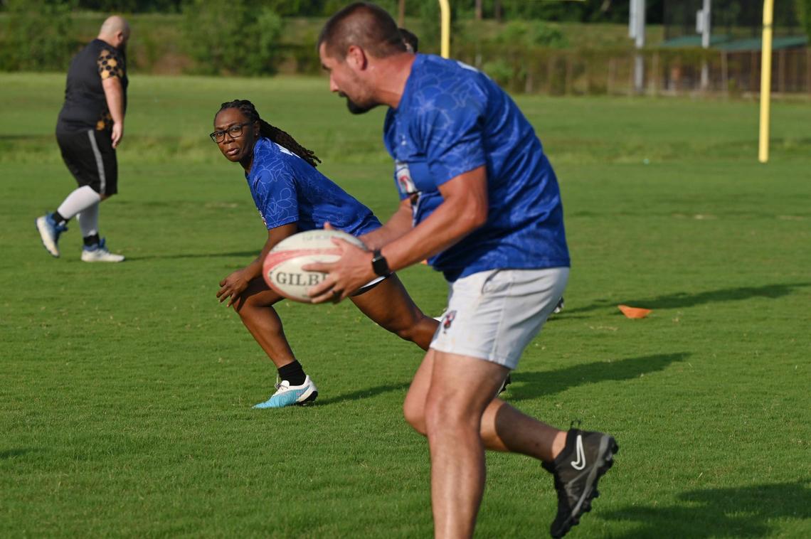 Tiyuana “T” Grant (left) runs during passing drills with Chad Keith at Macon Love Rugby practice on Thursday, Aug. 8, 2024, at Central City Park in Macon, Georgia. Macon’s amateur rugby team is expanding by competing with an all-female team at a summer competition this weekend.
