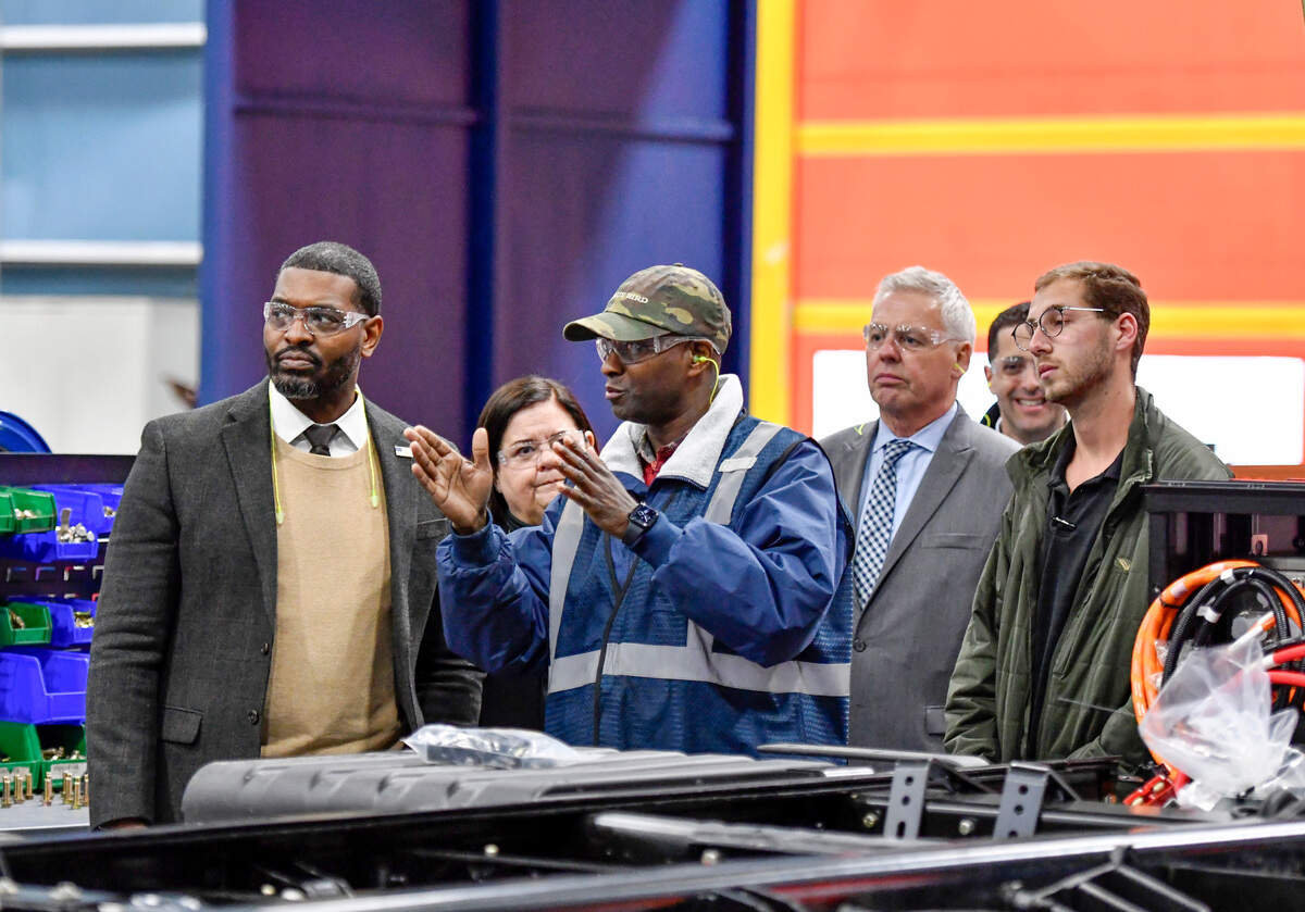 Troy Edmonds, center leads a tour of the Blue Bird’s EV bus production line for EPA Administrator Michael Regan, left at the manufacturer Monday afternoon. Regan announced the latest funding for clean school buses at an event in Dekalb County earlier in the day.