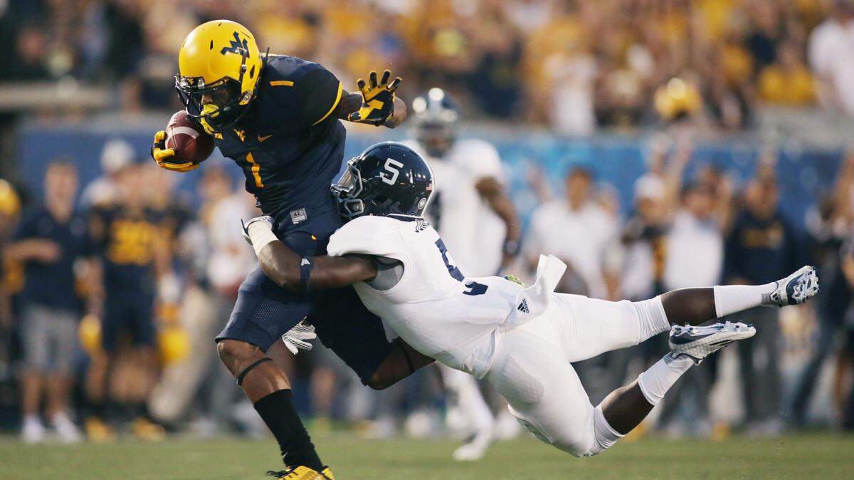 West Virginia wide receiver Shelton Gibson (1) is tackled by Georgia Southern cornerback Darius Jones (5) in the first half of an NCAA college football game, Saturday, Sept. 5, 2015, in Morgantown, W.Va. (AP Photo/Raymond Thompson)