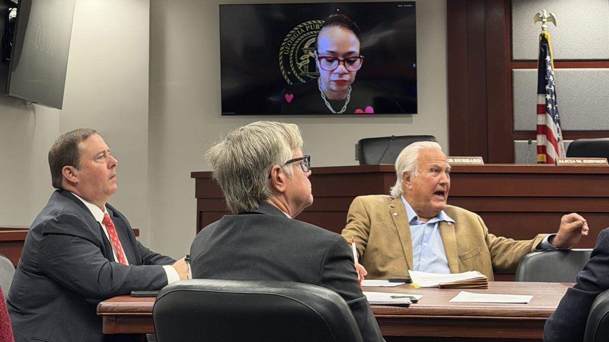 Georgia Public Service Commissioners Jason Shaw (left) and Bubba McDonald speak while commissioner Alicia Johnson joins virtually at a hearing on Thursday, Feb. 12, 2026, in Atlanta, Georgia. The hearing focused on the Southern Environmental Law Center’s motion to reconsider the commission’s approval of Georgia Power’s 10 gigawatt expansion plan.