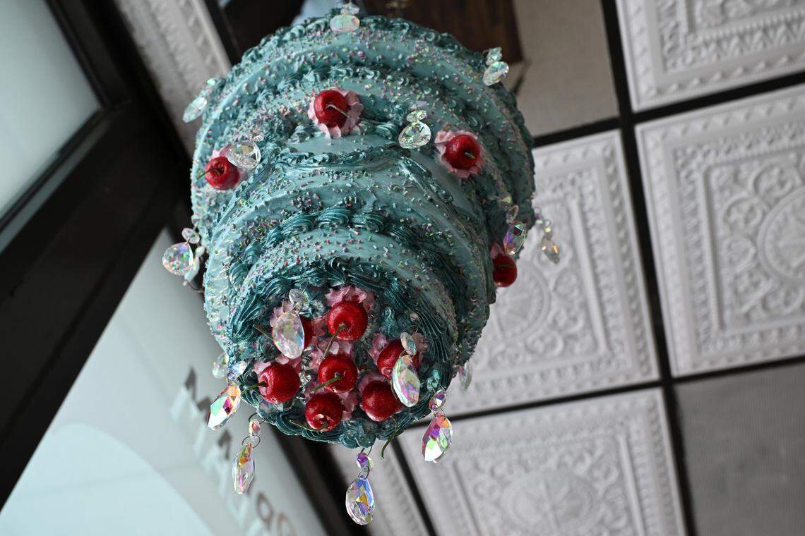 A cake chandelier hangs from the ceiling of the new Mad Hatter Cafe & Confections in Warner Robins.