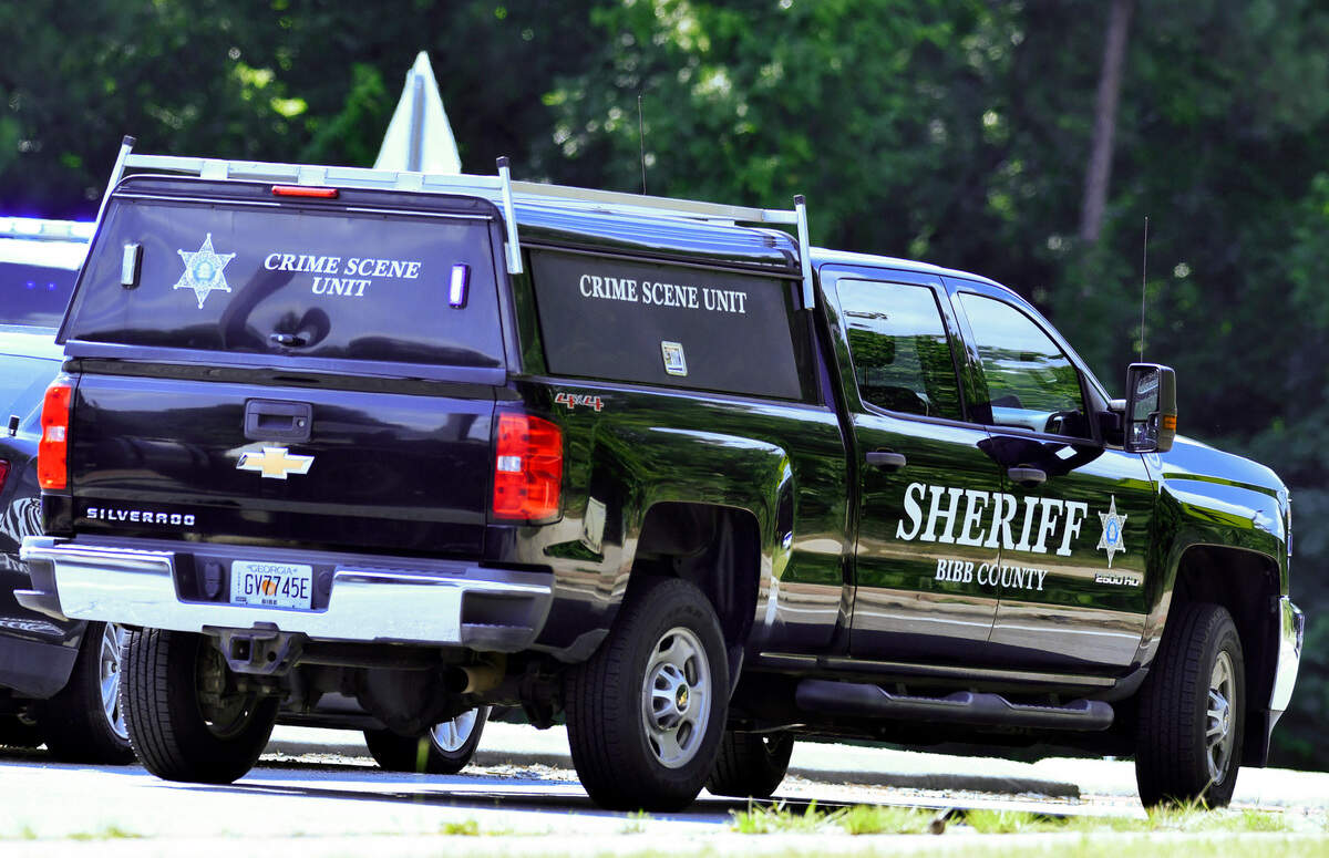 A Bibb County crime scene unit vehicle is parked in a roundabout during a search for suspects who reportedly fired at undercover Bibb County Sheriff’s deputies Monday afternoon in West Bibb County.