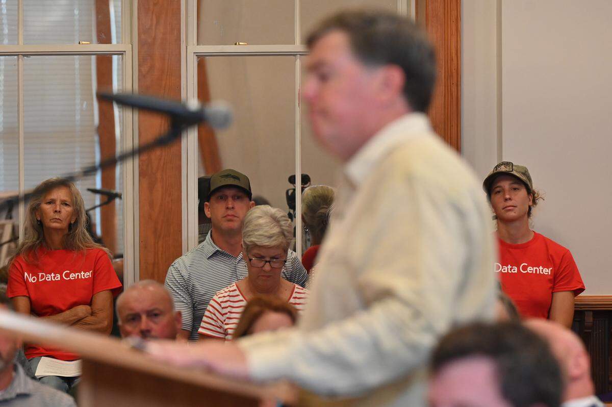 Opponents to the proposal for a Twiggs County data center listen to Eagle Rock Developers partner Ken Loeber on Thursday, Sept. 18, 2025, in Jeffersonville, Georgia. Twiggs County commissioners voted unanimously to approve the rezoning of agricultural land into land for a potential data center with some conditions at their September commissioner meeting amid backlash from many county residents. 