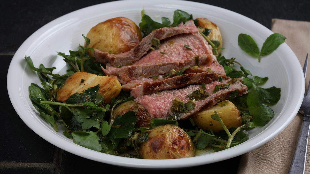 E. JASON WAMBSGANS/CHICAGO TRIBUNEPotatoes are grilled with fresh herbs, paired with grilled sirloin and served with peppery watercress.