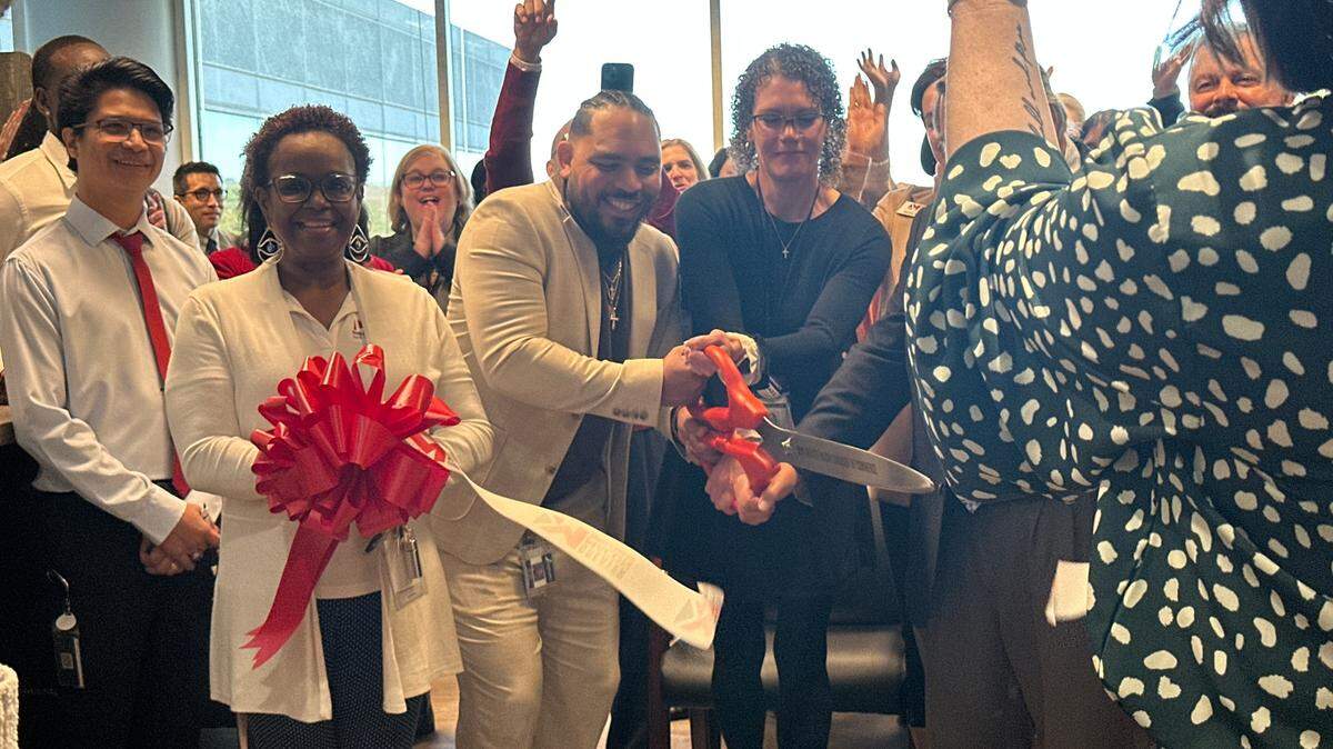 Holly Ireland, interim director of the HOPE Center, joins health care professionals and community members in unveiling the clinic’s new location on Thursday, Jan. 9, 2025. The new space on Arkwright Road promises to bring new services and more privacy to patients.