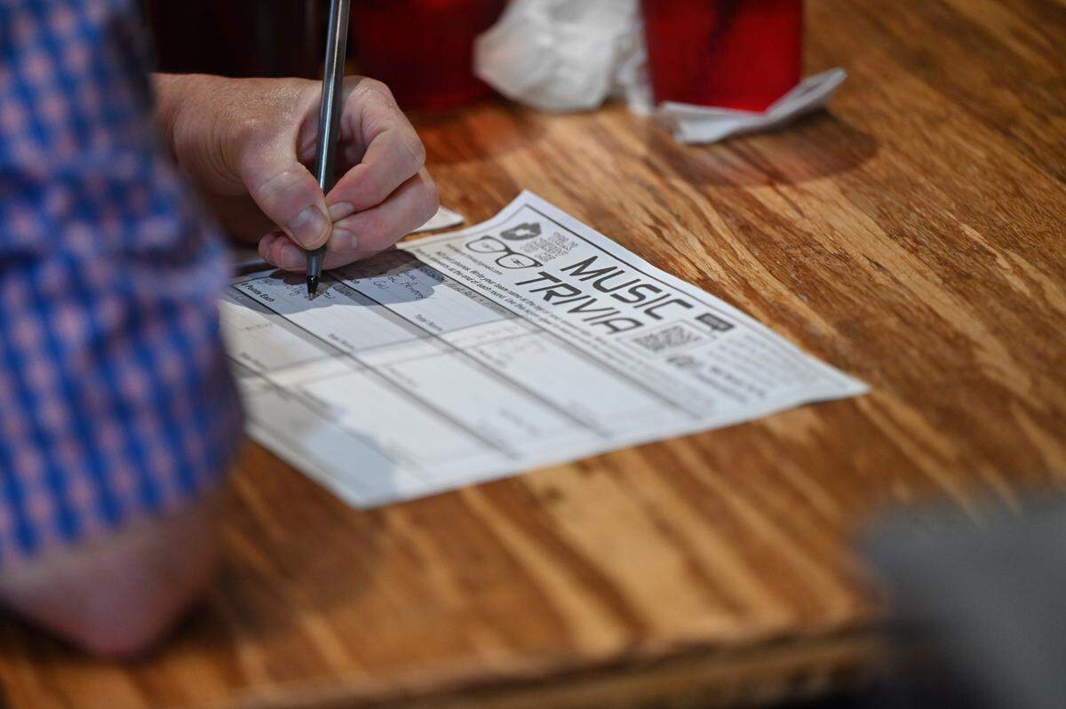 Chad Walton writes down an answer in in Music Trivia on Wednesday, Feb. 5, 2025, at The Library Tap Room and Kitchen in Macon, Georgia. The Library hosts weekly Music Trivia hosted by Talk Nerdy to Me, a local business that hosts themed trivia throughout Middle Georgia. 
