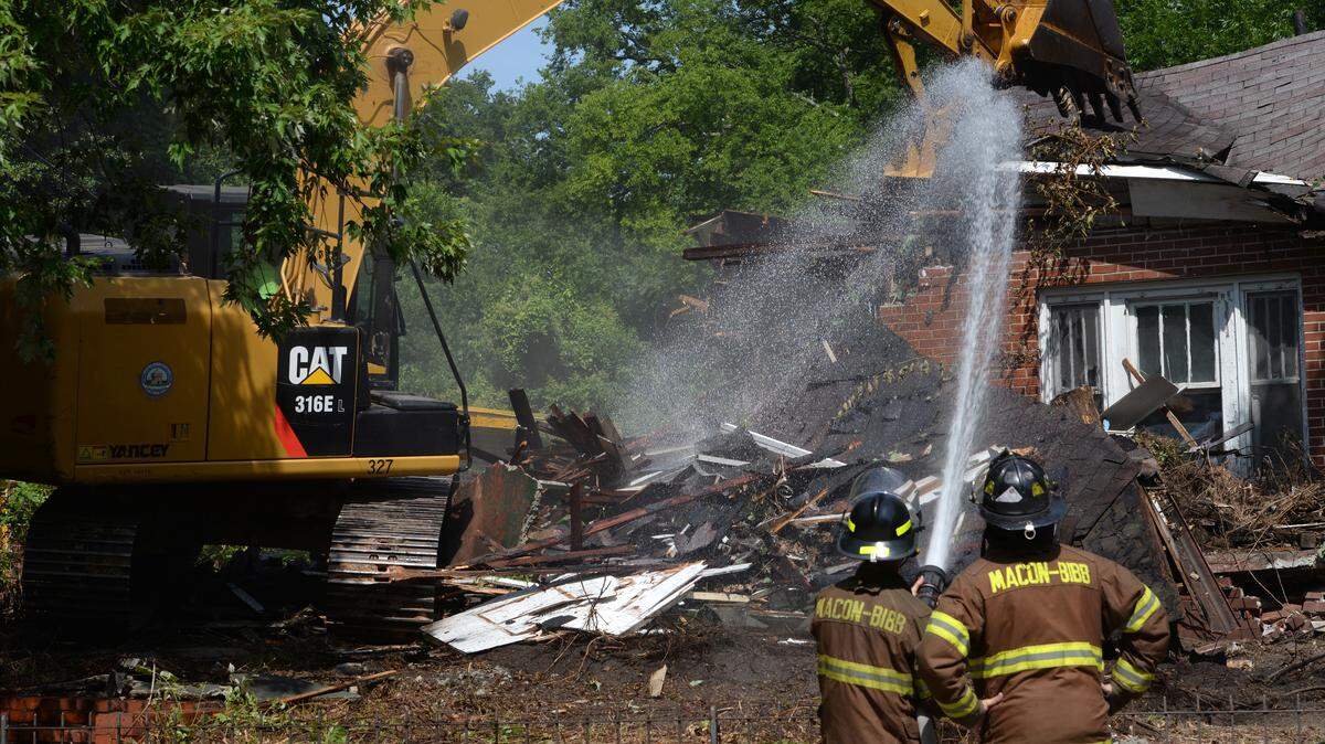 Macon-Bibb County employees tear down a blighted home at 743 Monroe St.