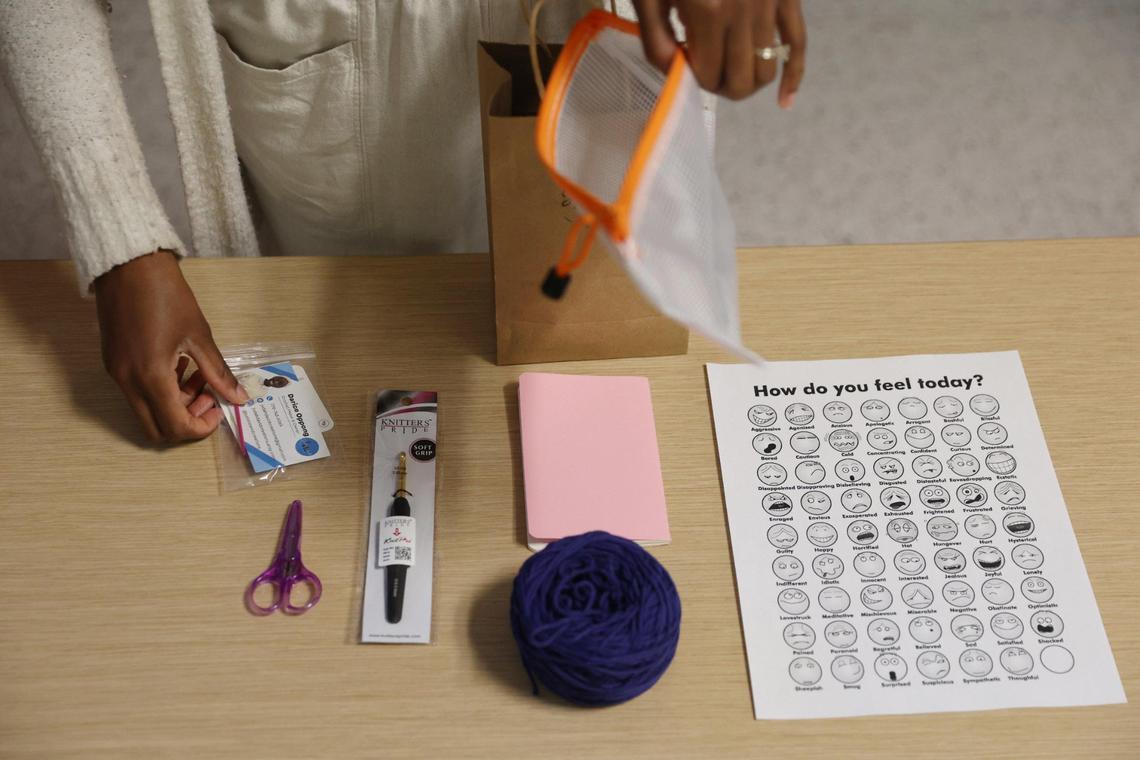 Judah David Creations owner Darice Oppong unpacks one of her kits for her beginner crochet classes during NICU support group on Wednesday, Dec. 19, 2024, at the Beverly Knight Children’s Hospital in Macon, Georgia. Oppong teaches her beginner crochet class to the support group for NICU parents, a resource she said she needed while in NICU with her son Judah David Oppong last year.