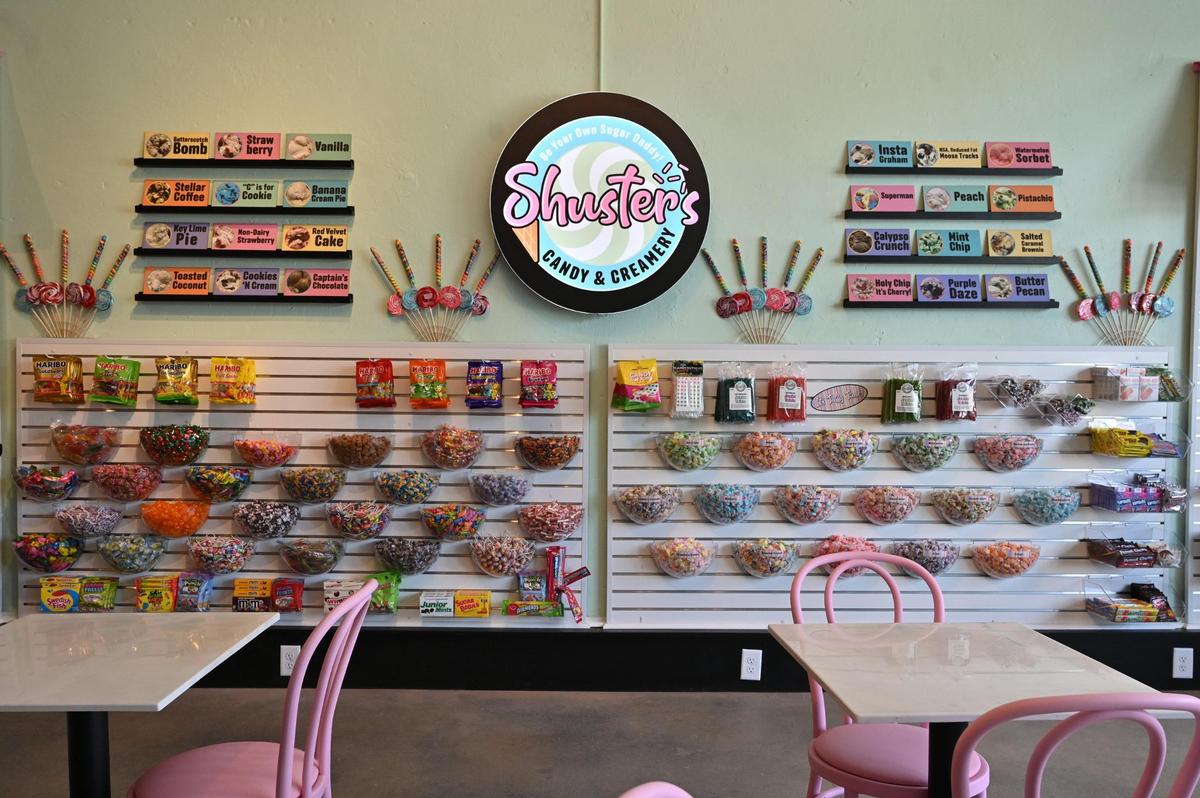 Candy and a list of ice cream flavors hang on the wall inside of Shuster’s Candy and Creamery on Friday, July 18, 2025, in Macon, Georgia. Owners Jonathan and Tennille Shuster wanted to create the atmosphere of an old fashioned candy shop with a contemporary twist.