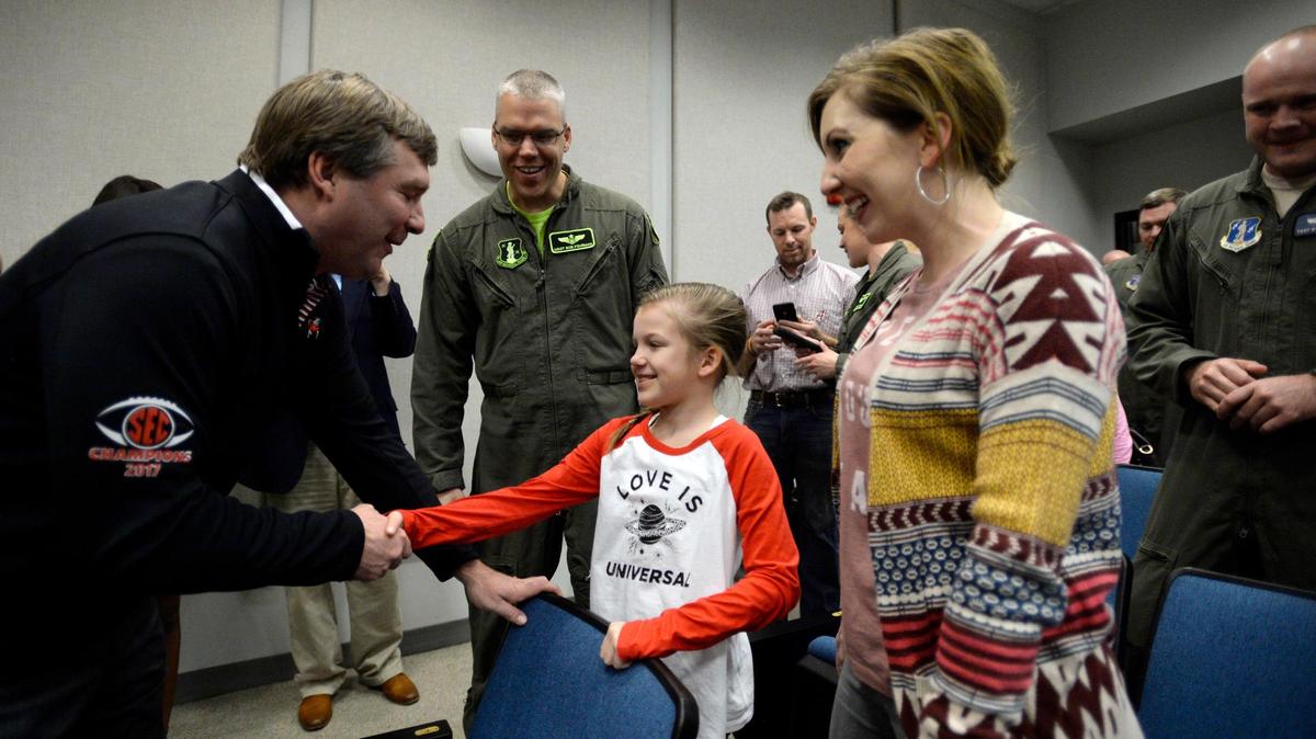 Georgia head football coach Kirby Smart, left, shakes hands with Darby Fourman after telling the Bulldogs coach she was a Red and Black fan. Smart visited troops like her father, Bob, center, and family members of the 116th ACW at Warner Robins Air Logistics Center Friday who are about to go on an extended deployment.