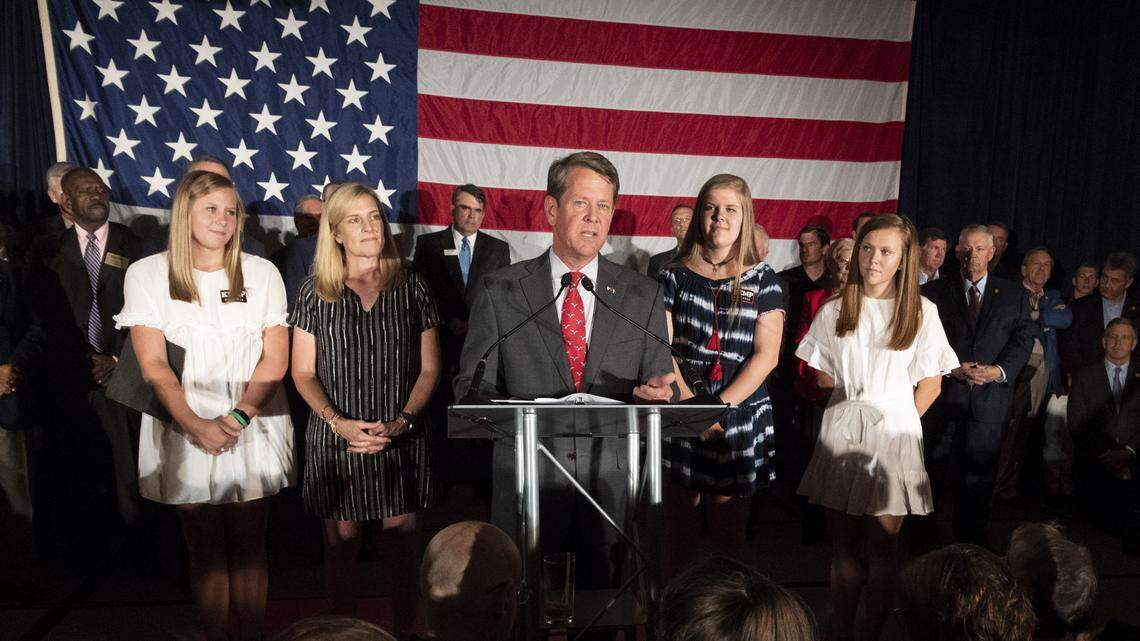 Georgia Secretary of State Brian Kemp, backed by family, speaks during a unity rally July 26 in Peachtree Corner.