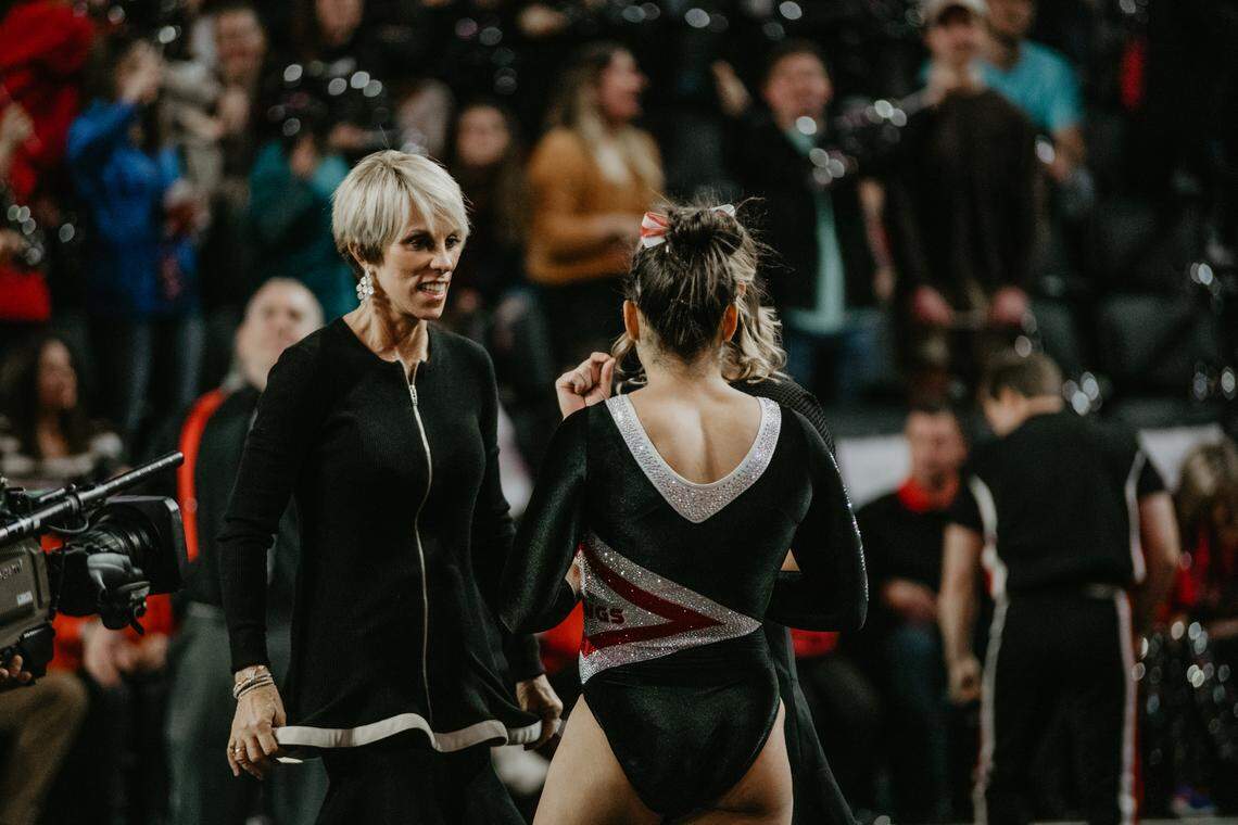Volunteer assistant coach Suzanne Yoculan Leebern advises a University of Georgia gymnast during a meet against Arkansas on Feb. 1, 2019.