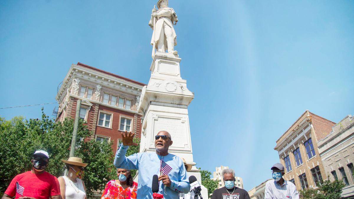 Former mayor Jack Ellis speaks to the media out front of the Confederate statue at the corner of Second Street and Cotton Avenue Friday to ask the city to move the state to Rose Hill Cemetery.