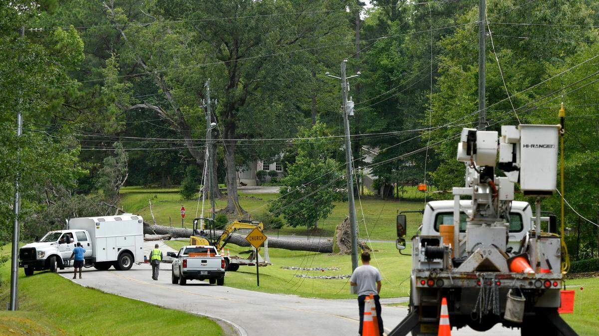 Crews work on a downed tree and lines along Price Road in west Bibb County Monday afternoon.