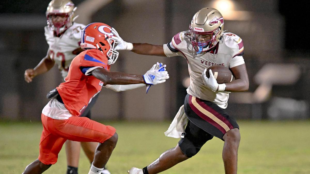 Westside High running back Kadiphius Iverson shoves off a Central defender and picks up a first down in action Friday night at Henderson Stadium.