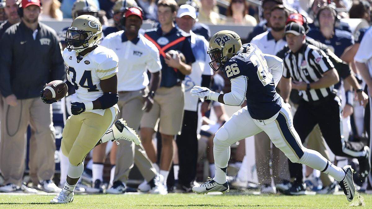 Georgia Tech running back Marcus Marshall (34) runs the ball against Pittsburgh defensive back Jevonte Pitts (26) during the first half of an NCAA college football game, Saturday, Oct. 17, 2015, in Atlanta. Marshall scored a touchdown on the play.