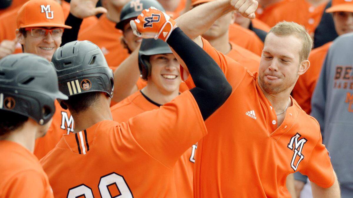 Mercer catcher Jose Hernandez (29) gets congratulated by teammates after his solo home run in the bottom of the fifth inning during their game against Radford Sunday.