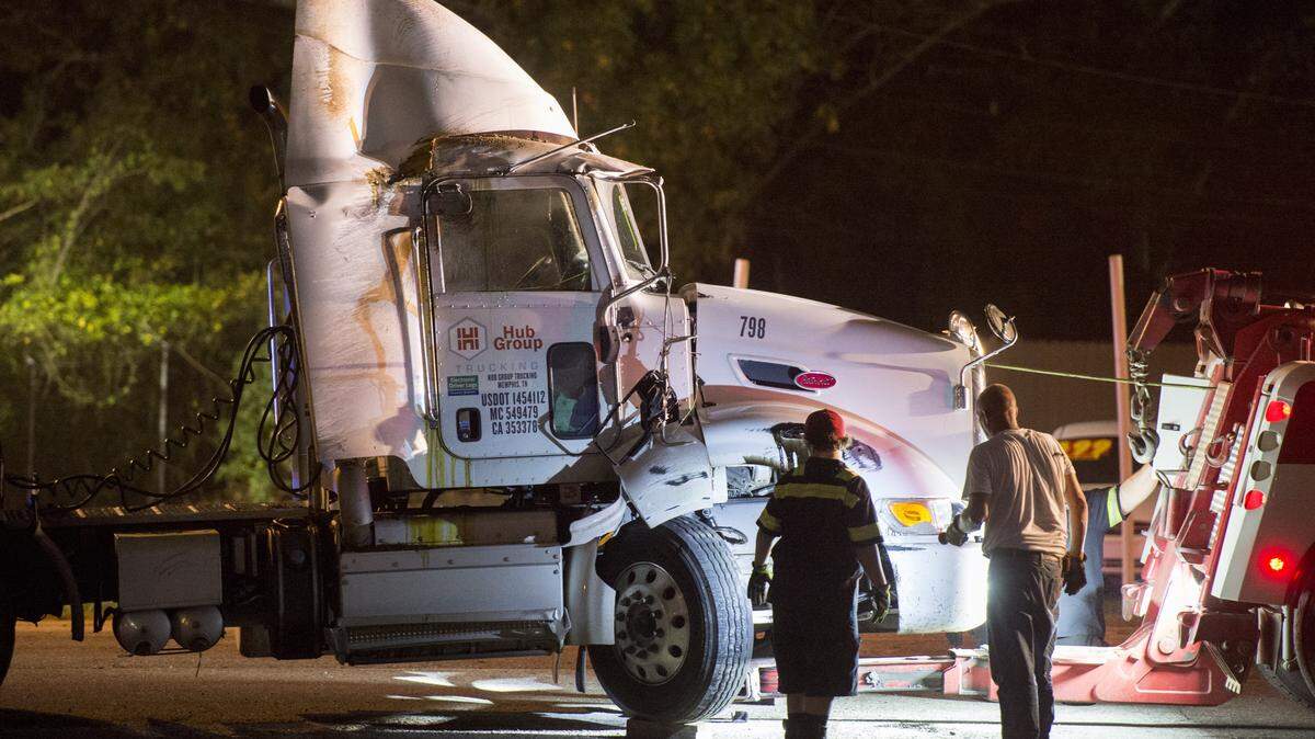 JASON VORHEES/THE TELEGRAPH Macon, GA, 11/04/2015: 
 A crew with Mike Adams Towing hook up a tractor trailer that tipped over heading northbound on Pio Nono Avenue near the intersection with Houston Avenue, Broadway and Houston Road Wednesday night.