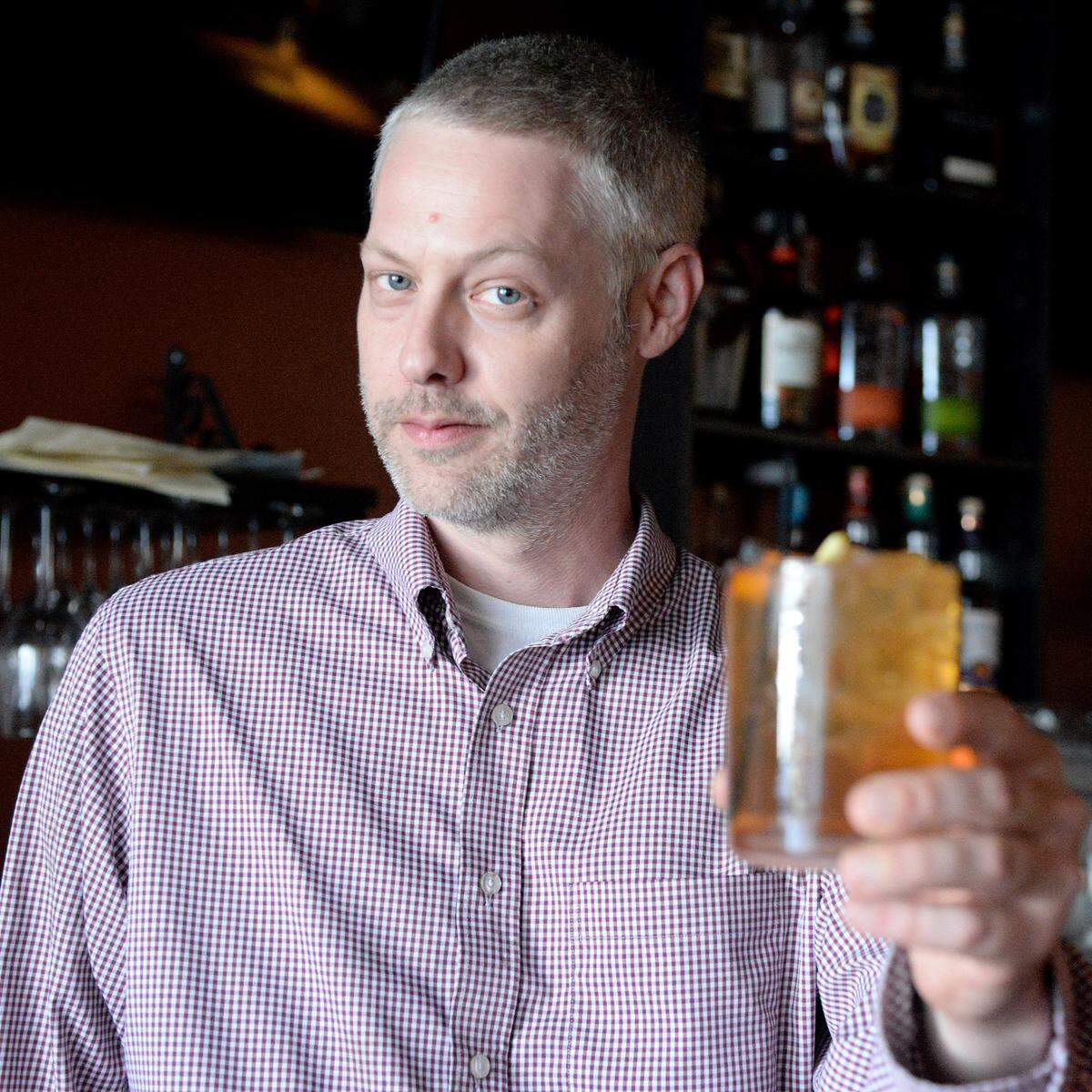 Josh Howard, a bartender, makes a Cedar Smoked Old Fashioned at Miramar Raw Bar and Tapas on Forsyth Road in Macon.