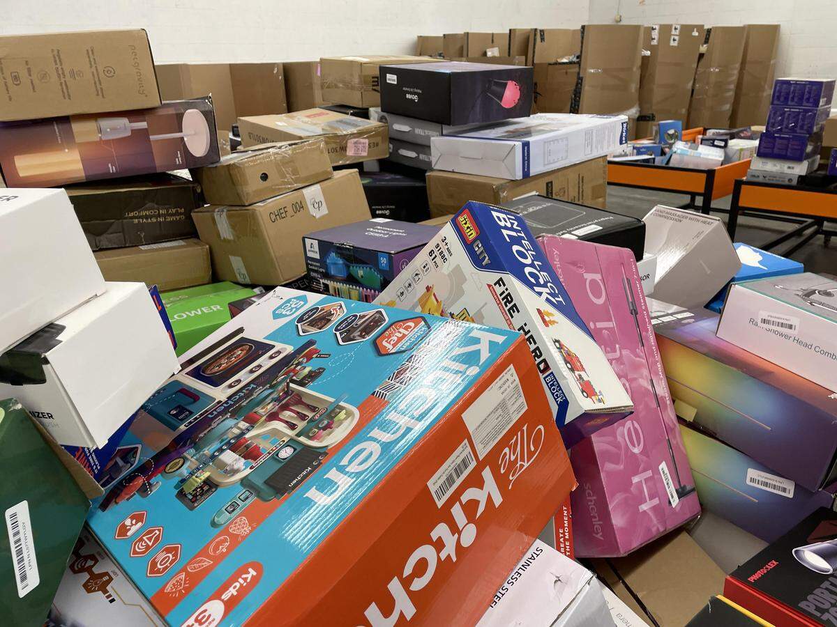A variety of discounted merchandise in bins in the distribution area of the new Deals Outlet gearing up to open in Warner Robins.