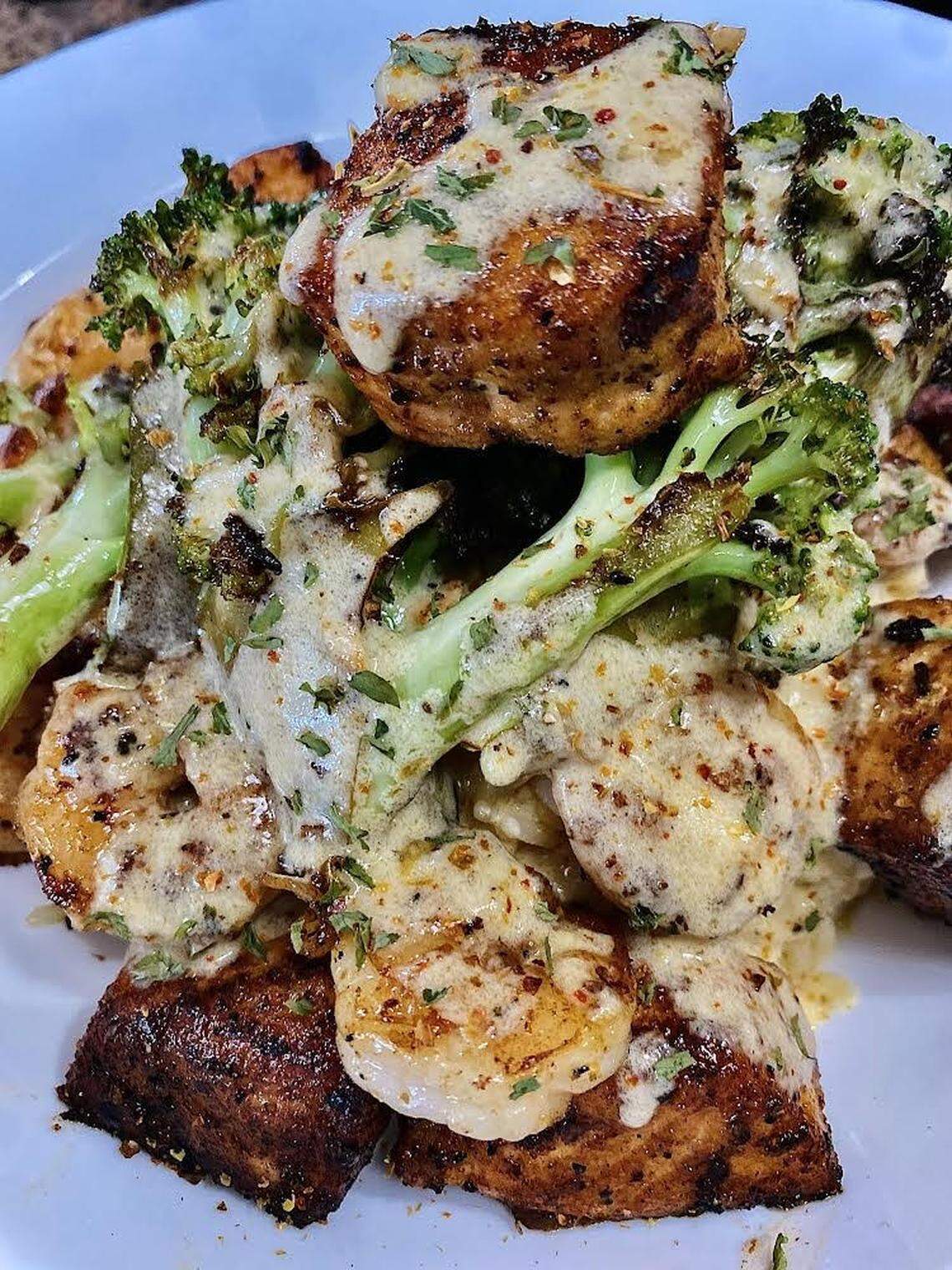 Salmon bites, sauteed shrimp and sauteed broccoli over risotto rice with a special sauce from ABC Catering LLC food truck.