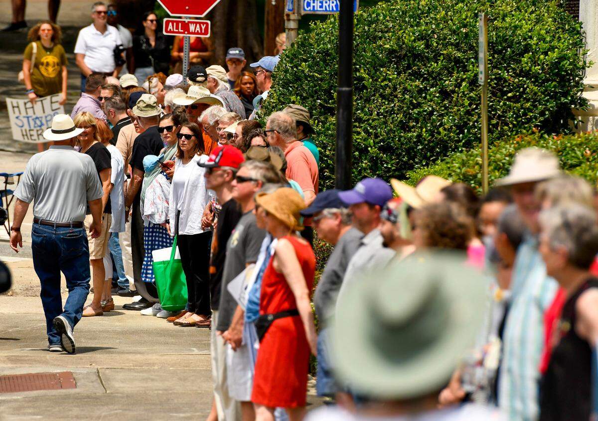 Hundreds of people hold hands around Temple Beth Israel Saturday afternoon for a counter-protest after an antisemitic hate group gathered outside the Temple Friday.