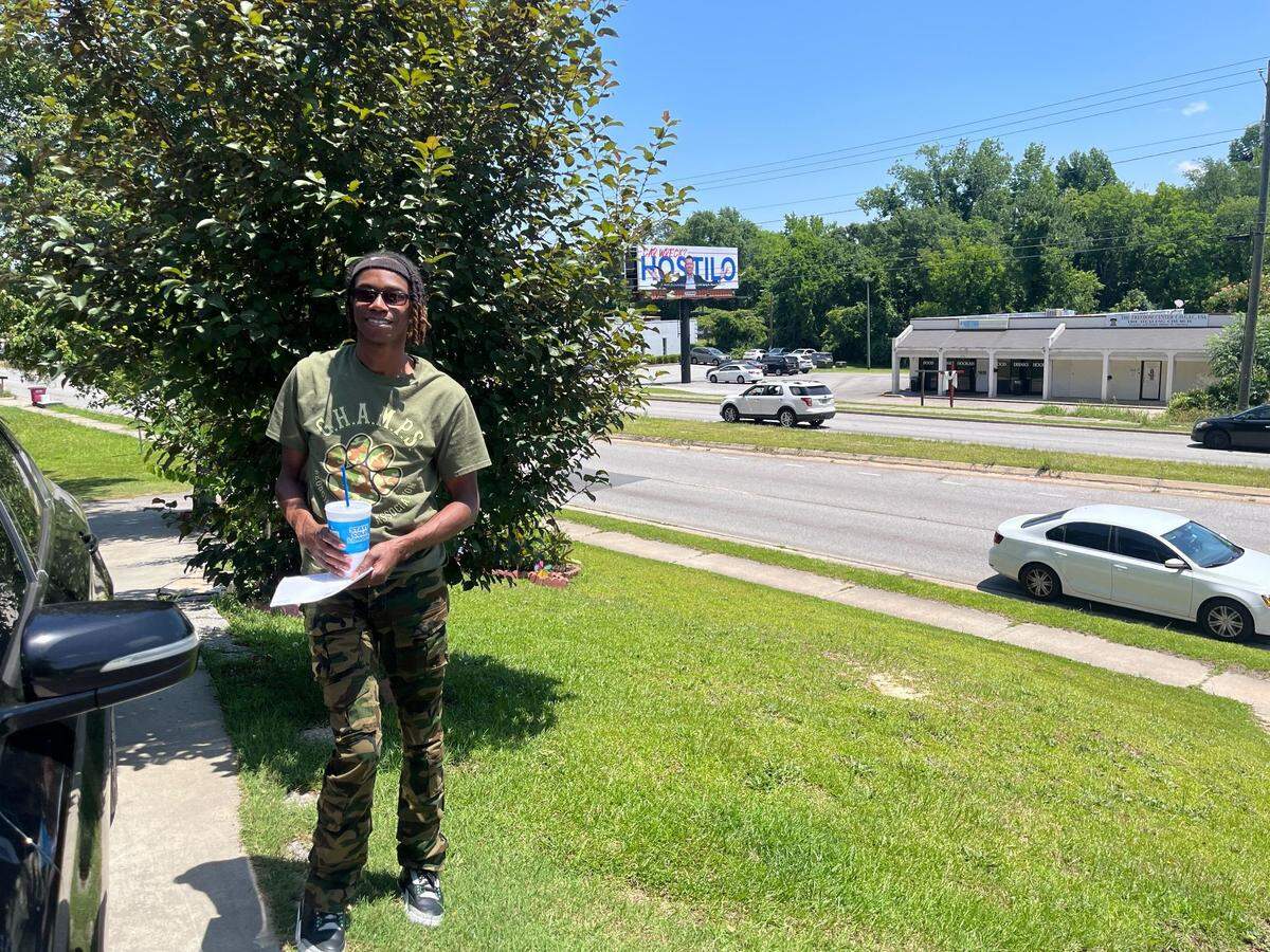 Alex Perkins stood in his front yard, across the street from Midtown Daiquiri Bar & Grill on Tuesday, May 20, 2025, on Log Cabin Drive in Macon, Ga. Perkins said he witnessed a shooting that happened at the bar’s plaza on Sunday.