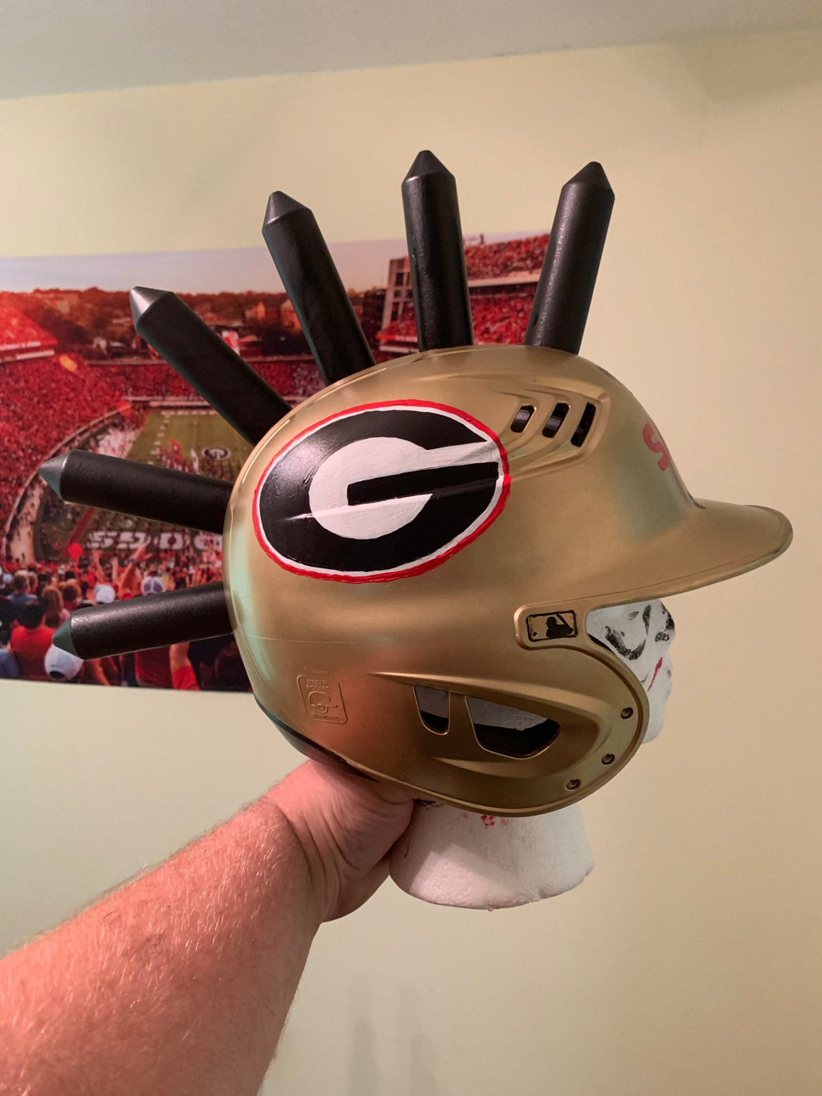 The Savage Helmet was created by Georgia baseball fans to help players celebrate home runs. It was spray painted with gold paint and adorned with six spikes.
