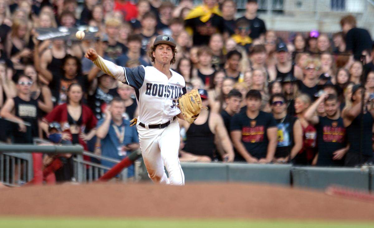 Houston County third baseman Drew Burress (8) throws to first after a diving stop during game one of the BearsÕ GHSA 6A Championship series against Lassiter Wednesday in Atlanta.