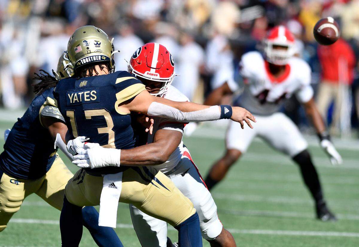 Georgia Tech quarterback Jordan Yates (13) is hit by Georgia linebacker Nakobe Dean (17) as he releases the ball during the Bulldogs 45-0 win Saturday in Atlanta.