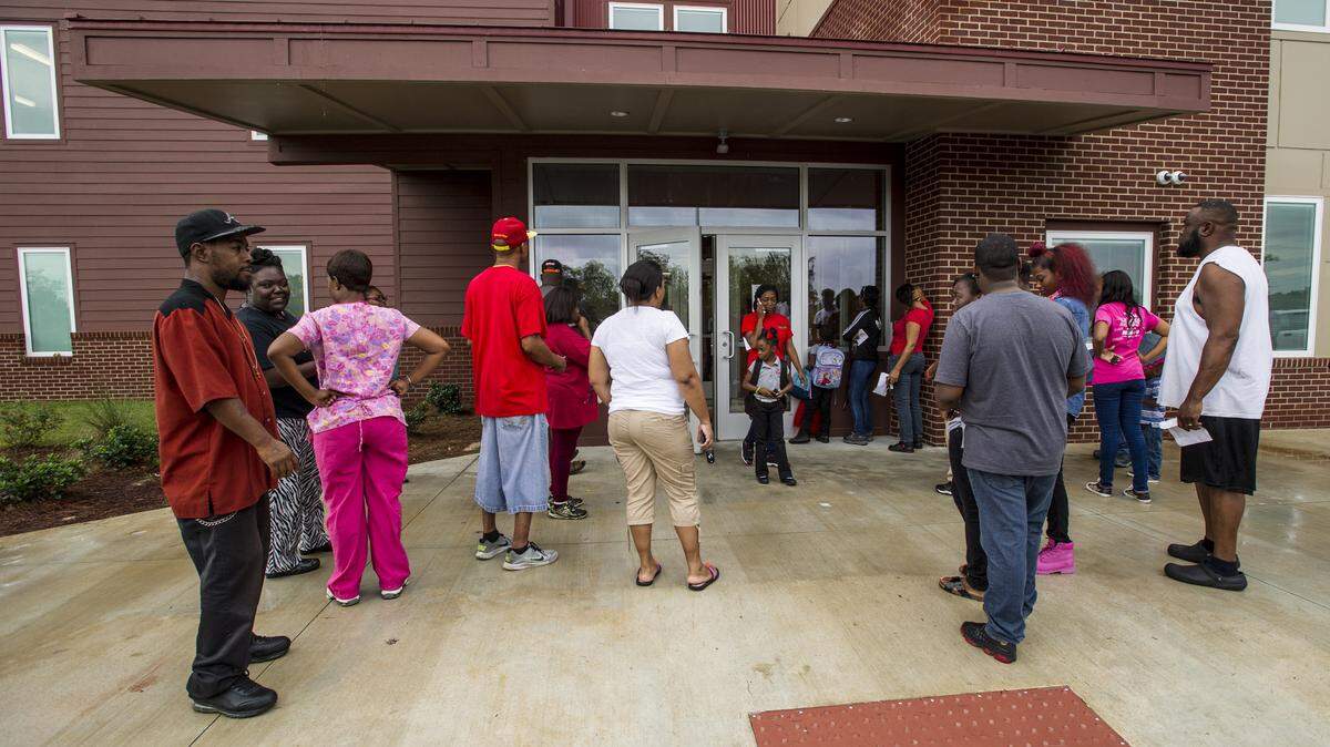 Parents wait outside Macon Charter Academy for school to be dismissed in October.