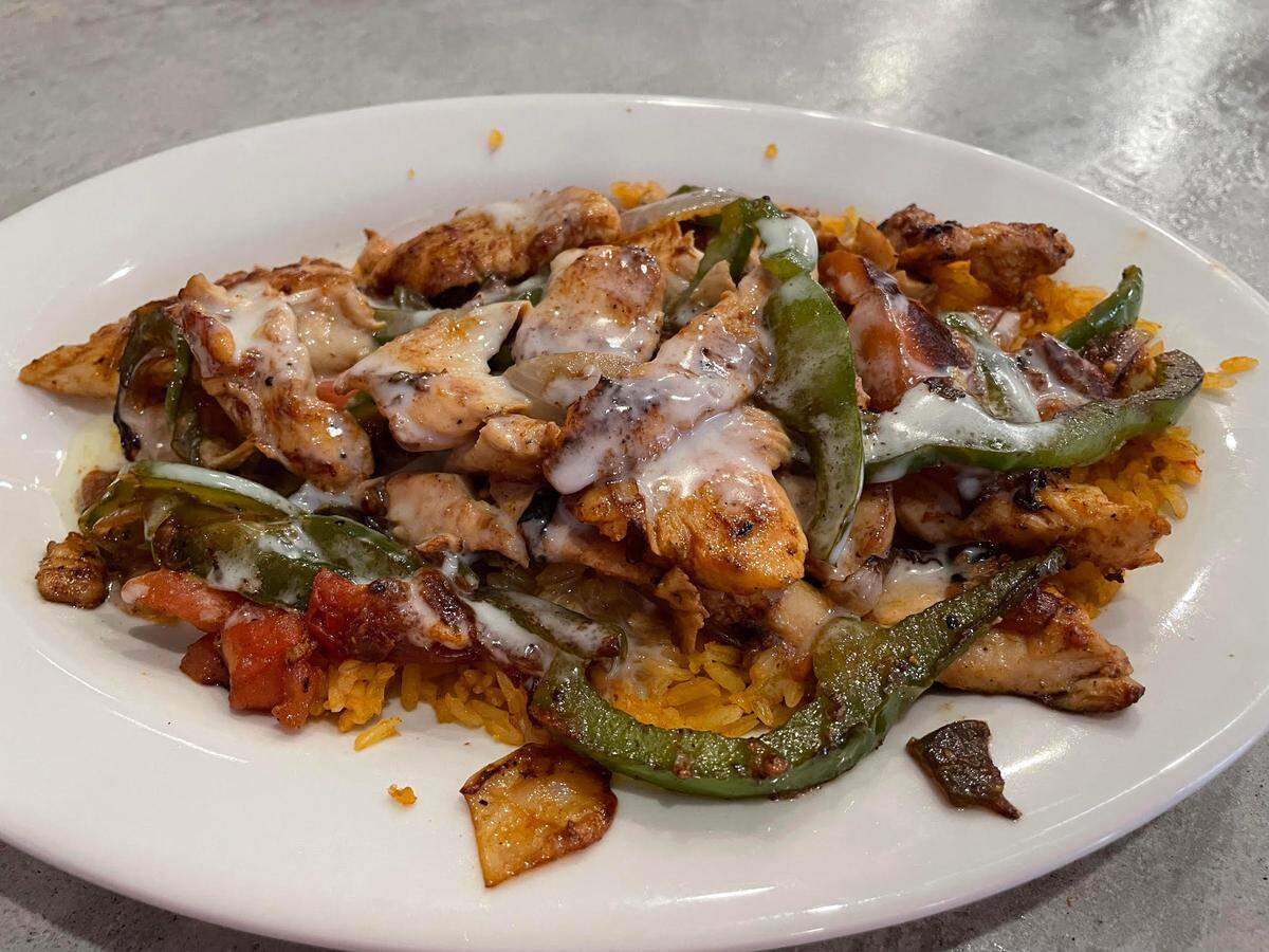 The Agave Special at the Lazy Donkey in downtown Macon includes grilled steak or chicken, onions, peppers and tomatoes on a bed of rice and topped with cheese dip.