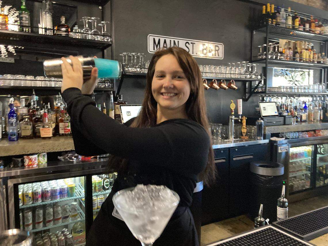 Jamie Stricklen shakes up a Blue Christmas cocktail at the family’s Main St. Bar, a new upscale bar in downtown Perry that celebrates its grand opening Friday.
