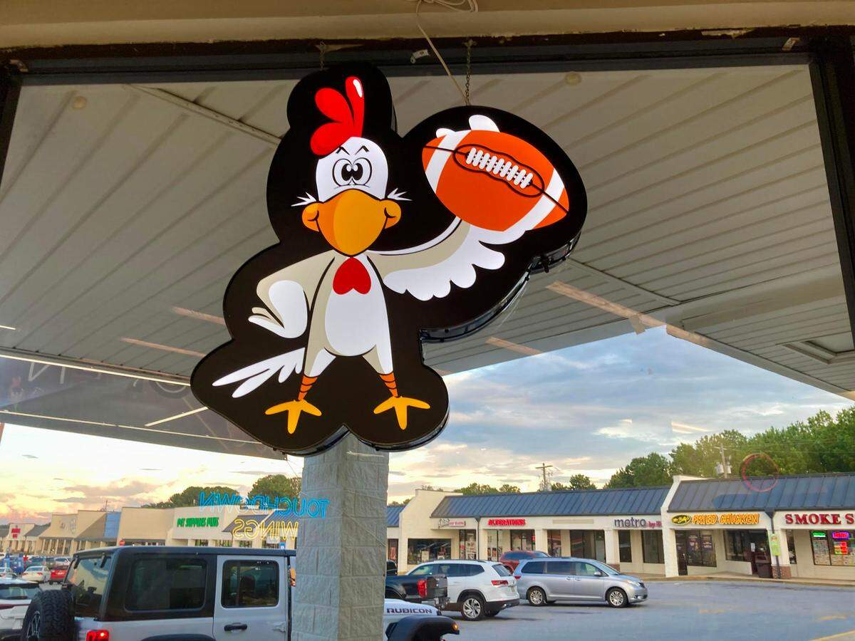 A TouchDown Wings logo hangs in a window of a new TouchDown Wings restaurant in the Kroger shopping center off Russell Parkway in Warner Robins.