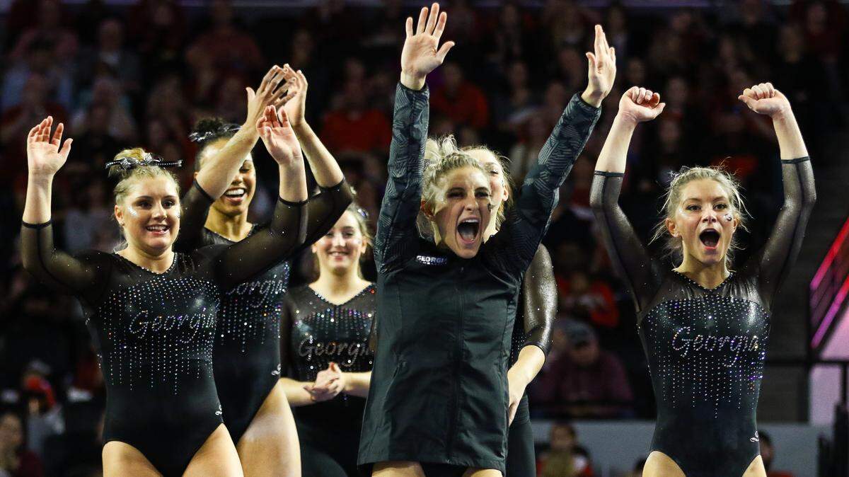 Georgia’s gymnastics team celebrates during a gymnastics meet between the University of Georgia and Ohio State University in Stegeman Coliseum in Athens, Ga., on Saturday, Jan. 5, 2019. (Photo by Kristin M. Bradshaw)