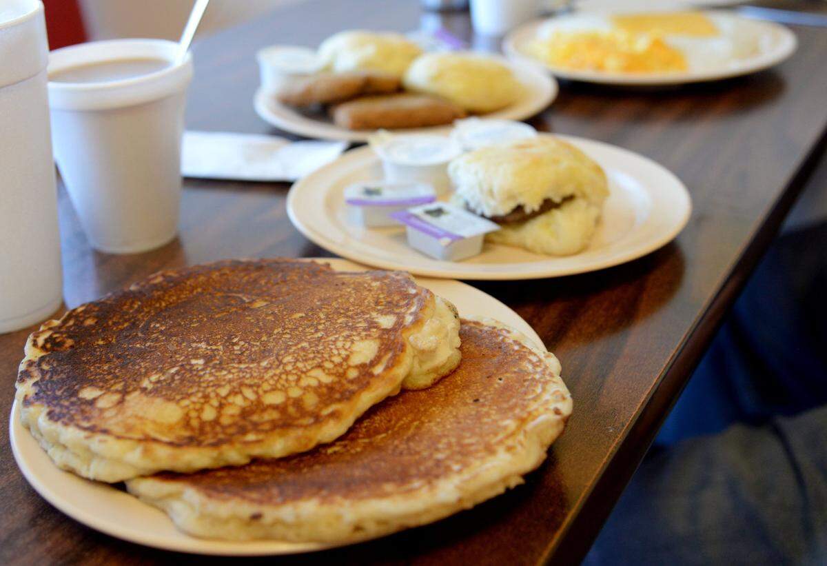 JENNA EASON/THE TELEGRAPH Macon, GA, 12/23/2019: Reporter Jenna Eason ordered pancakes and a sausage biscuit at Johnny V’s, and Reporter Justin Baxley ordered the steak breakfast platter for this week’s episode of #FoodieFriday.