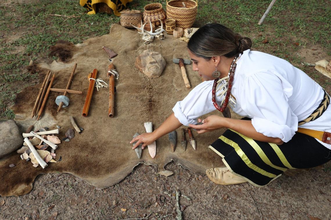 Walalalah Brown Tisho of the Eastern Band of Cherokee Indians places artifacts on a rug during the 2024 Ocmulgee Indigenous Celebration on Saturday, Sept. 14, 2024, at Ocmulgee Mounds National Historical Park in Macon, Georgia. Ocmulgee Mounds National Historical Park hosted its 32nd Ocmulgee Indigenous Celebration, which featured cultural dancing, storytelling and demonstrations from the Muscogee (Creek) Nation and other southeastern tribes.