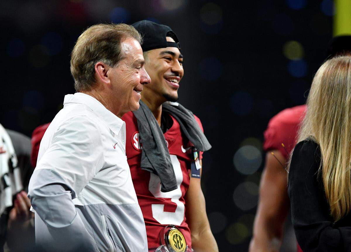 Alabama head coach Nick Saban and quarterback Bryce Young smile while on stage after the Crimson Tide’s 41-24 win over Georgia in the SEC Championship.
