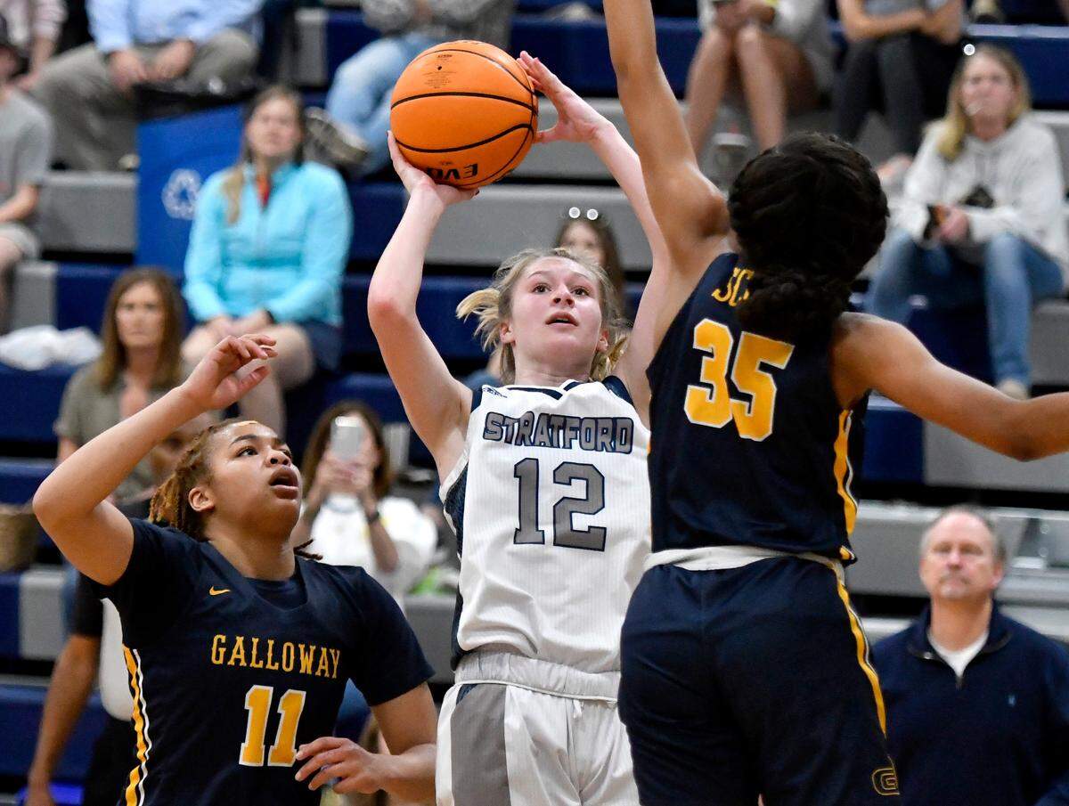 Stratford’s Gracie Jorgensen (12) puts up a shot over Galloway defenders Saturday during the Eaglettes’ 48-35 loss in their second round state playoff game.