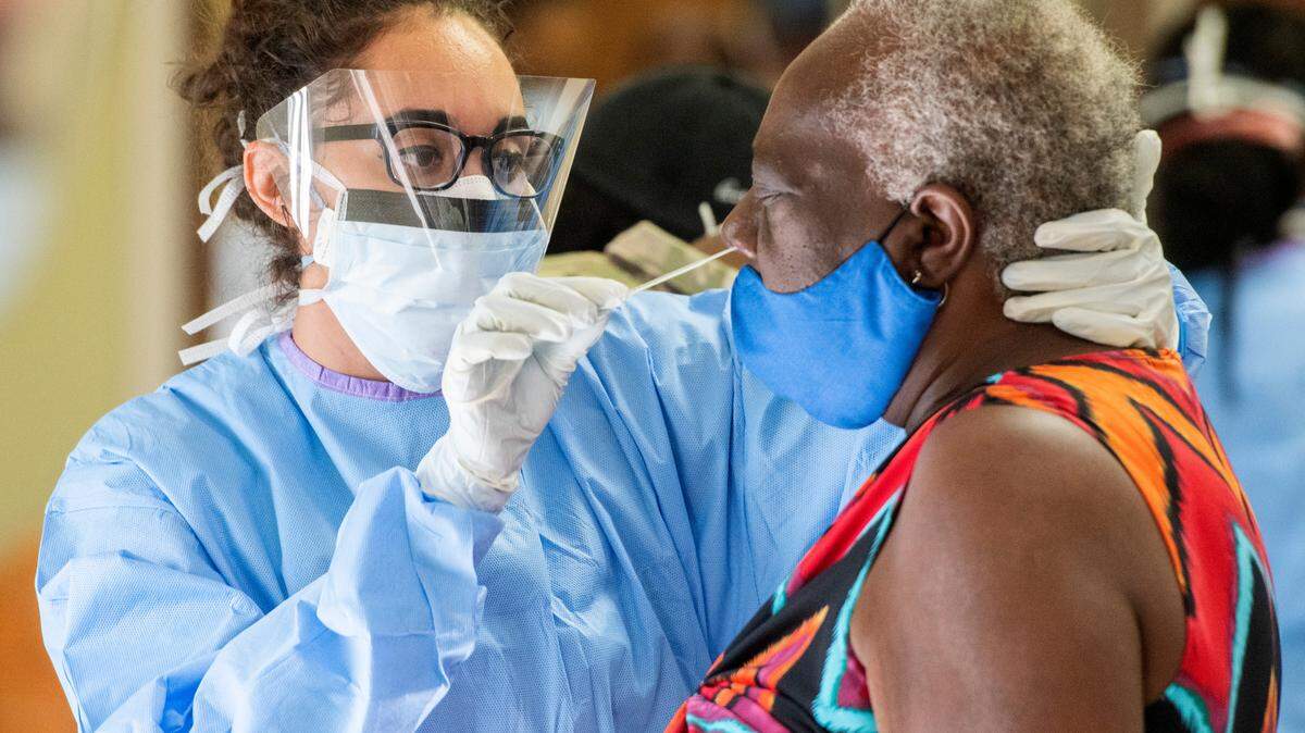 Sgt. Jessica Borg with the 148th Brigade Support Battalion performs a deep nasal swab COVID-19 test Tuesday at Ebenezer Missionary Baptist Church.