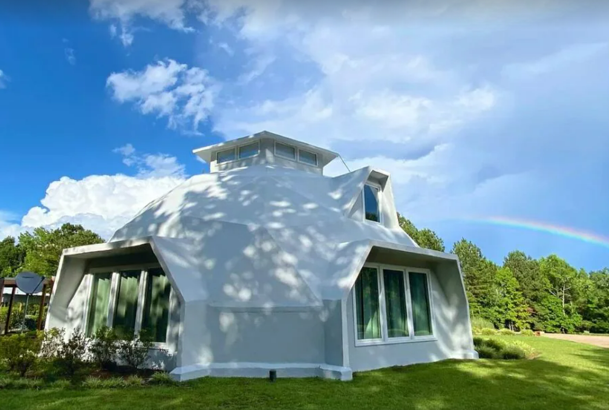 A rainbow in the background of this photo is just one of the beautiful ways nature will say hello to you at this stunning Luxury Dome.