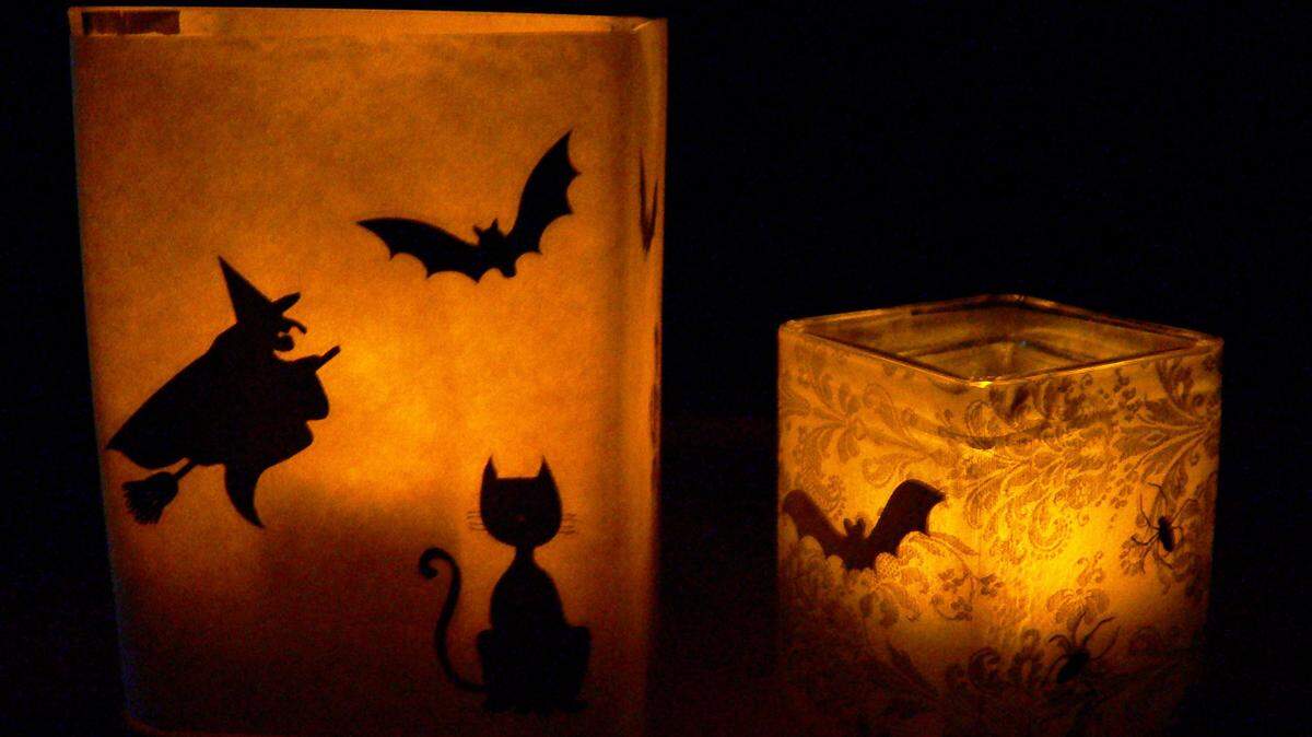 Cast a welcoming glow this Halloween with do-it-yourself luminaries. Attach black stickers to vellum or the waxy side of freezer paper and wrap around a clear glass vase, adhering with double-sided tape. Insert battery-operated votives and enjoy.